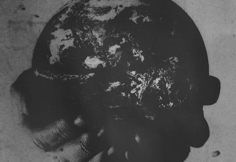 Monochrome artwork depicting a hand holding a globe-like form, symbolising burden and responsibility.